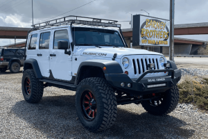 Top-Rated Off-Road Shop in Grand Junction, CO at Barney Brothers Off Road & Repair. Image of lifted Jeep Wrangler Rubicon with off-road upgrades, showcasing suspension, tire, and performance enhancement services.